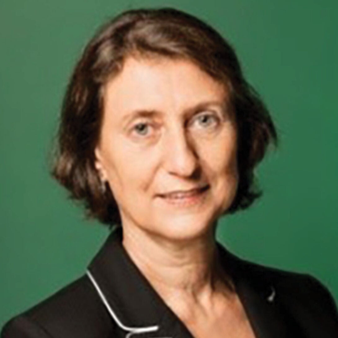 UIC Clinical Professor Eliane Karsaklian smiles at camera with green background